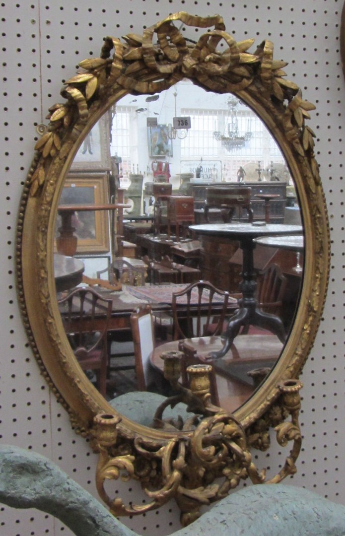 Appraisal: A th century gilt framed oval wall mirror with tied