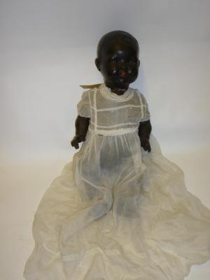 Appraisal: A Japanese bisque head black baby doll with brown glass