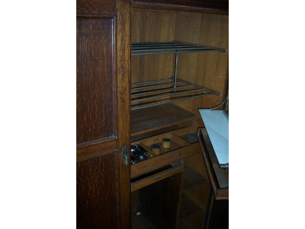 Appraisal: A Compactum Co Ltd gentleman's wardrobe enclosed by a pair