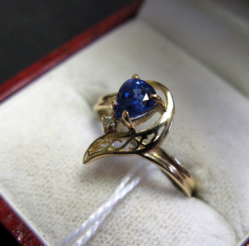 Appraisal: SAPPHIRE DIAMOND AND FOURTEEN KARAT GOLD RING set with a