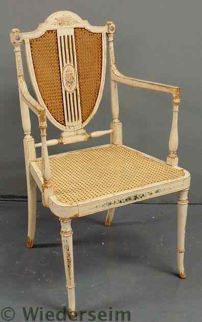 Appraisal: French white painted shield-back open armchair with caned back and