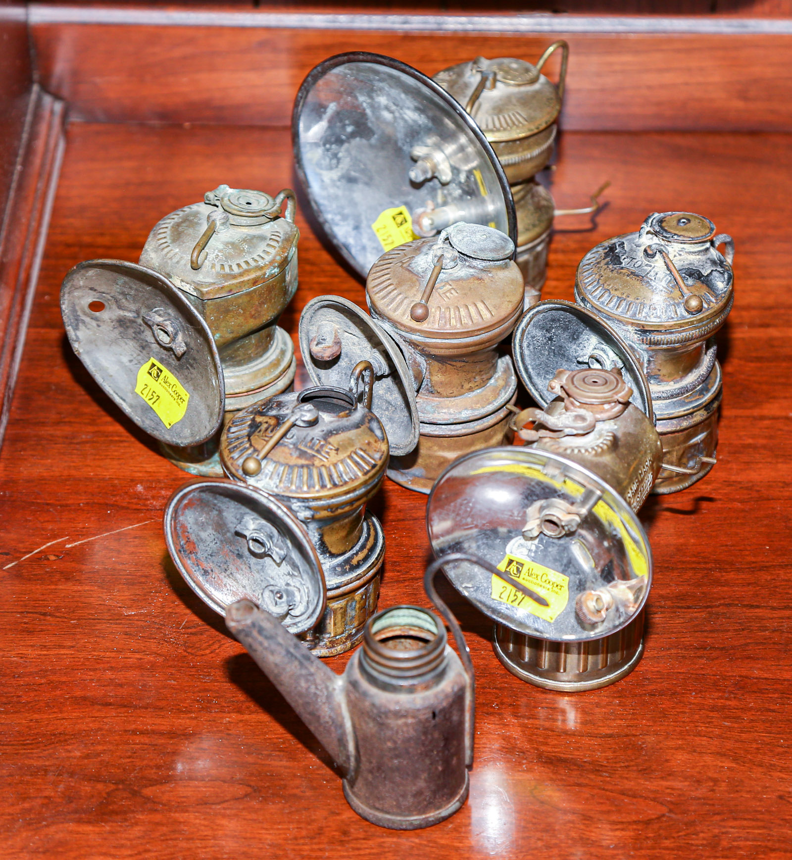 Appraisal: SIX CARBIDE MINER HELMET LAMPS With one fuel tin to