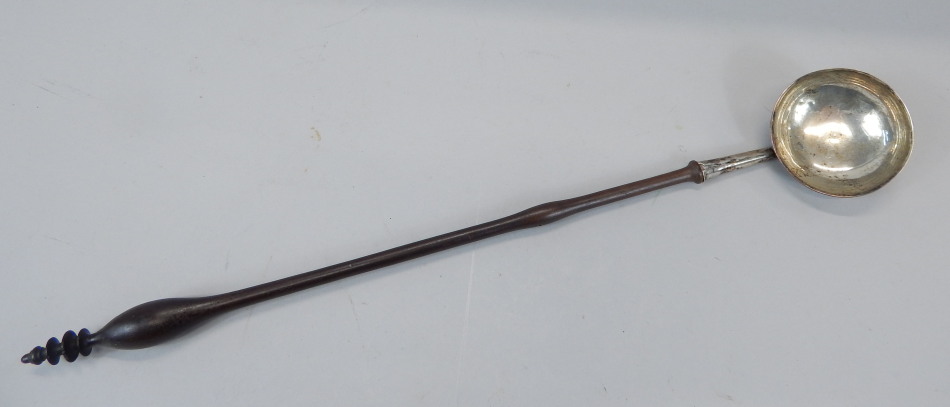 Appraisal: A thC continental white metal ladle with turned wooden handle