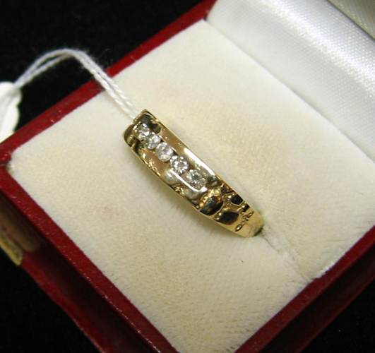 Appraisal: MAN'S DIAMOND AND FOURTEEN KARAT GOLD RING with five channel