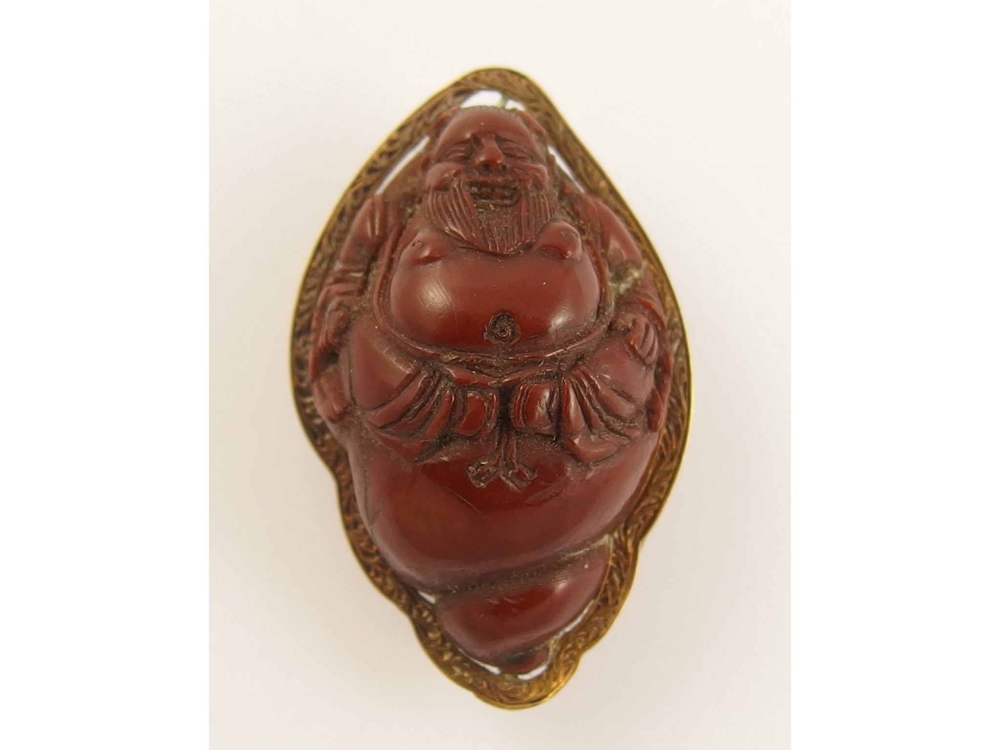 Appraisal: A carved nut netsuke depicting a Buddha sitting inside a