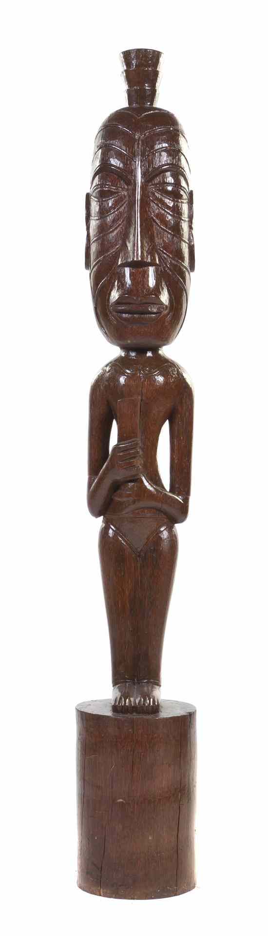 Appraisal: A Carved Wood Tiki depicted standing having an oversized head