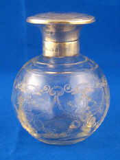 Appraisal: A silver mounted perfume bottle with engraved swags and flowers