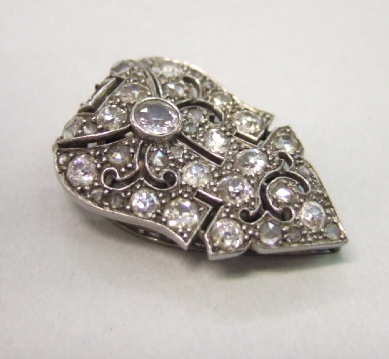 Appraisal: A diamond set dress clip in a pierced geometric design