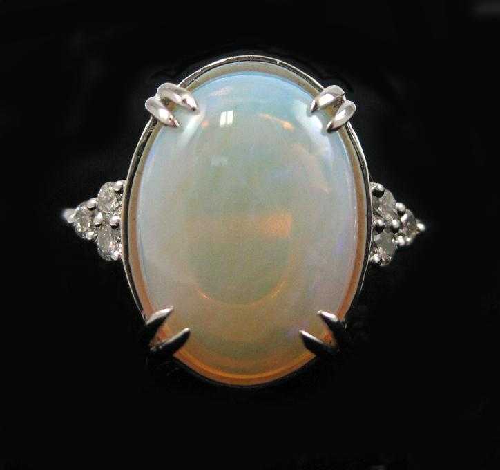 Appraisal: OPAL DIAMOND AND FOURTEEN KARAT WHITE GOLD RING with three