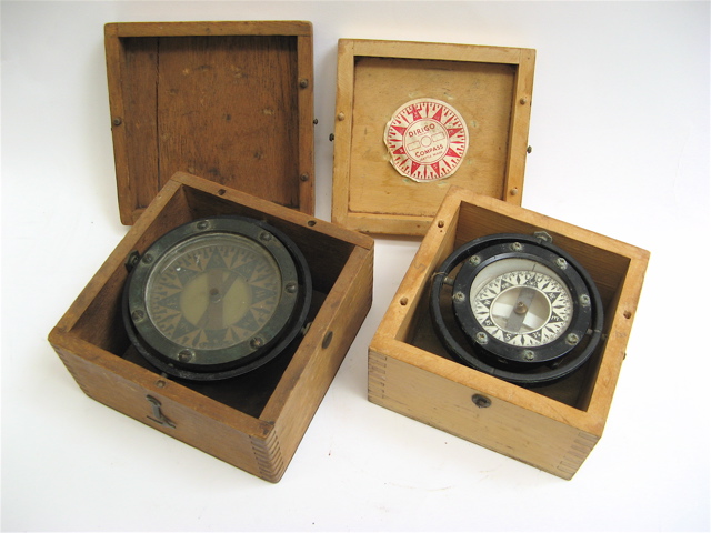 Appraisal: TWO SHIP'S COMPASSES mounted in lidded wood boxes One with