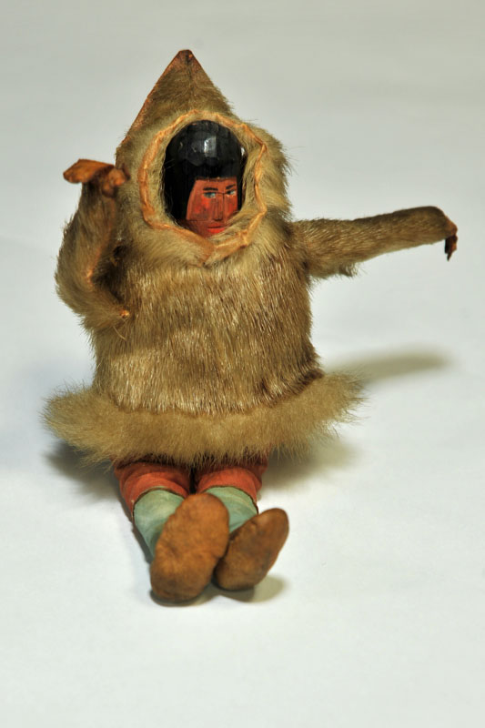 Appraisal: INUIT DOLL Carved and painted wood head cloth body leather