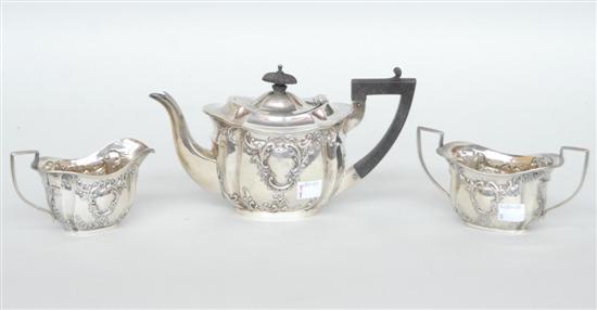 Appraisal: A THREE PIECE ANTIQUE CHASED ENGLISH TEA SERVICE Comprising a