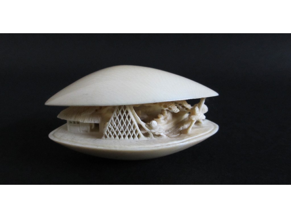 Appraisal: A Japanese carved ivory clam shell carved with fishermen by