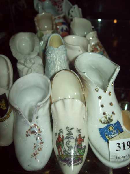 Appraisal: A HALF SHELF OF ELEVEN COLLECTABLE MINIATURE PORCELAIN SHOES