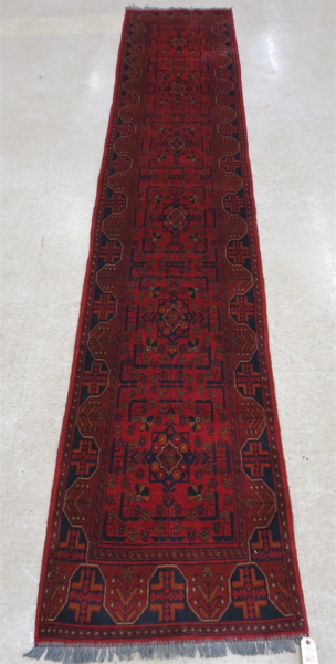 Appraisal: PAKISTANI TURKOMAN RUNNER hand knotted in a repeating flower-filled square