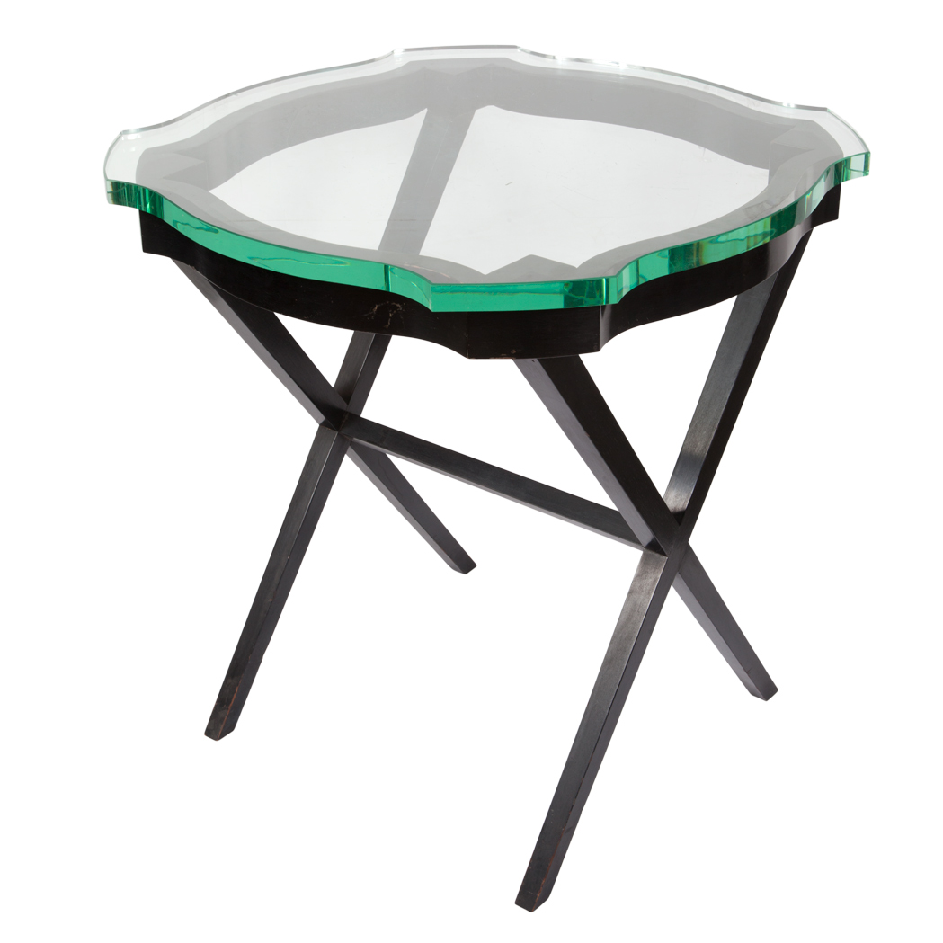 Appraisal: Black Lacquered Occasional Table The shaped circular glass top raised