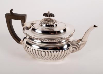 Appraisal: A silver teapot LF Birmingham half-ribbed with ebonised handle approximately