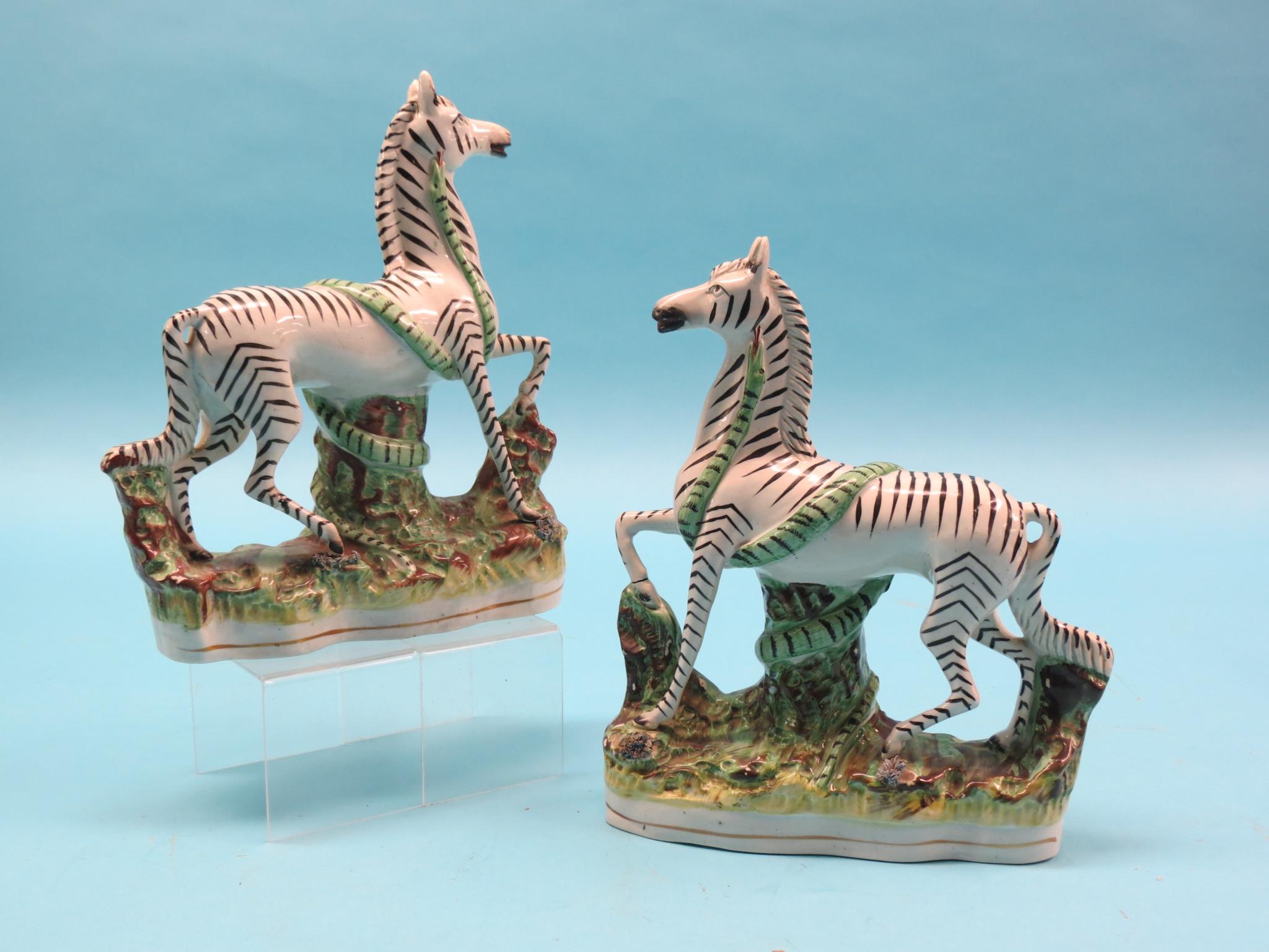 Appraisal: A pair of Victorian Staffordshire pottery zebras each with marauding