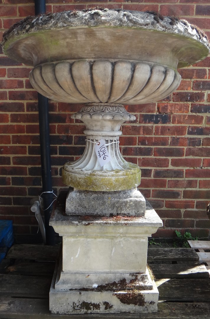 Appraisal: A large reconstituted stone planter on fluted soccle and stepped