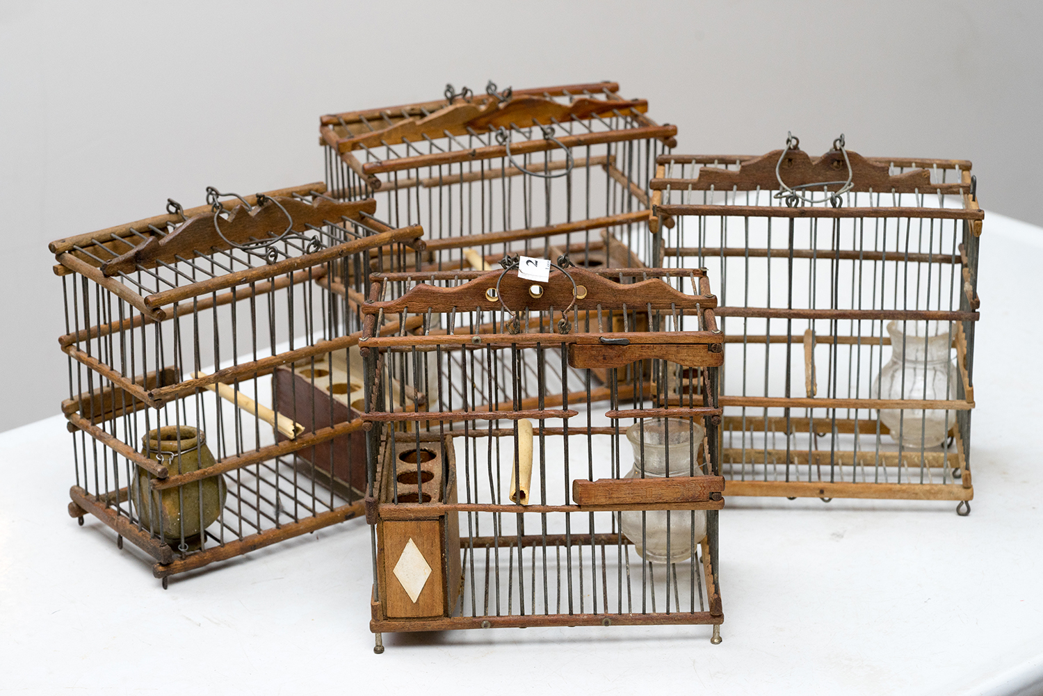 Appraisal: FOUR FRENCH ANTIQUE BIRD CAGES Glass terracotto and wired wood