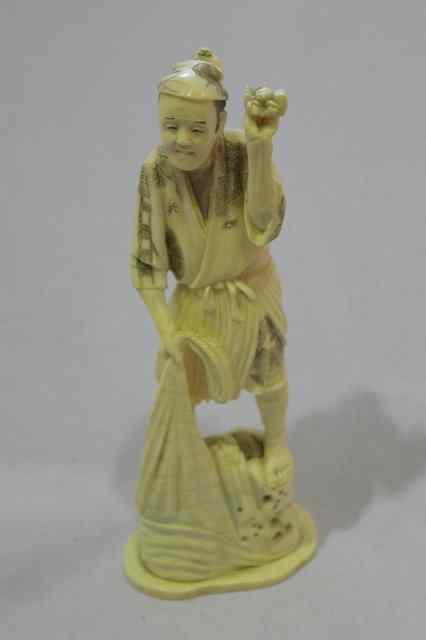 Appraisal: A JAPANESE CARVED IVORY MODEL of a fisherman pulling up