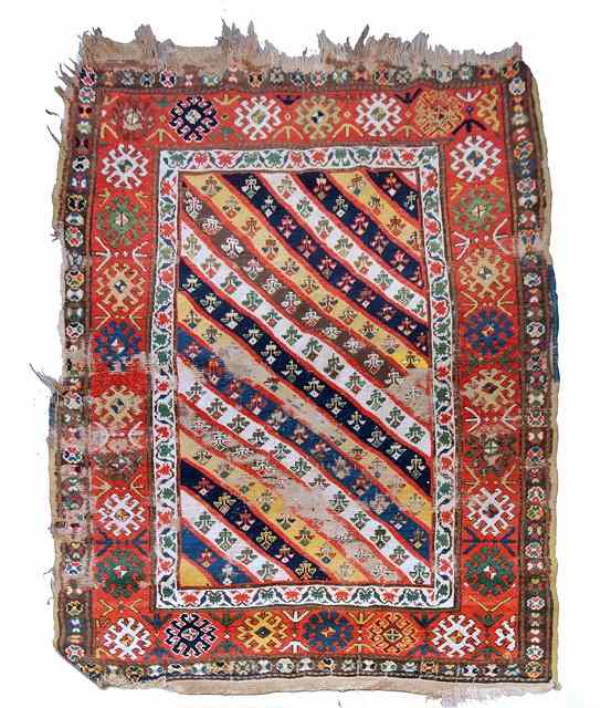 Appraisal: A CAUCASIAN MULTICOLOURED RUG the central diagonal and foliate panel