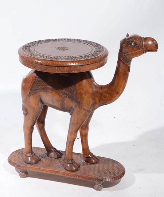 Appraisal: A DAMASCUS CARVED TABLE with standing camel support having a