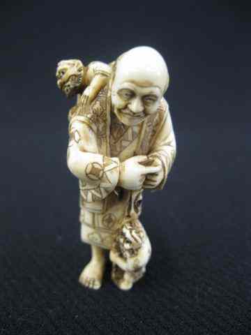 Appraisal: Carved Ivory Netsuke man with two oni or mischief makers