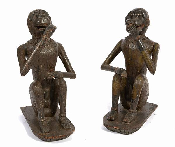 Appraisal: A pair of polychrome decorated models of seated monkeys height