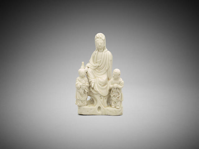 Appraisal: A Chinese dehua white-glaze figure group of Guanyin and two