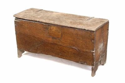 Appraisal: A Charles II boarded oak chest on cut out ends