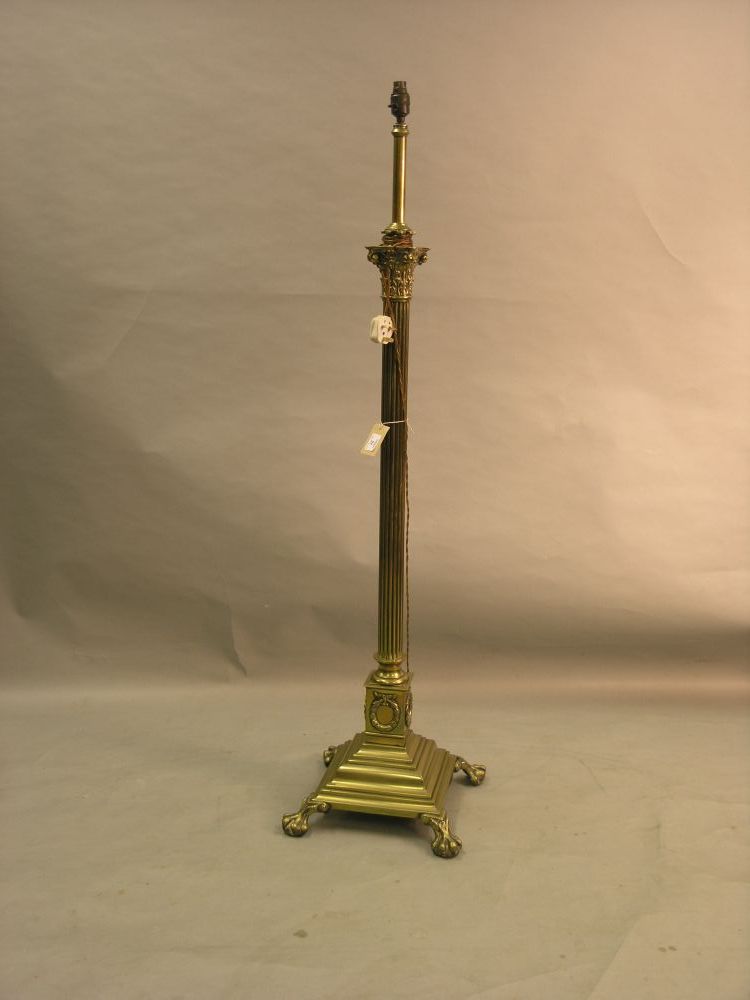 Appraisal: A brass standard lamp with corinthian column on stepped square