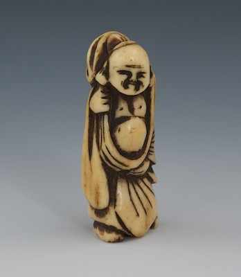 Appraisal: A Carved Staghorn Netsuke of Buddha Edo Period Standing figure