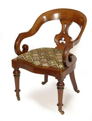 Appraisal: A Victorian mahogany open armchair the wrap around back with