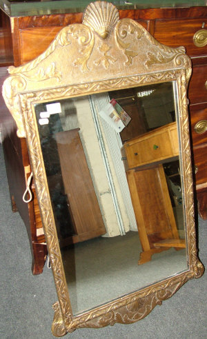 Appraisal: A giltwood wall mirror th century with scrolled acanthus shell