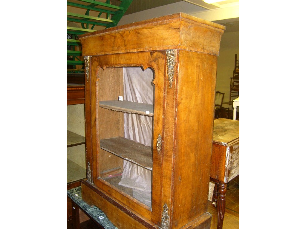 Appraisal: A Victorian walnut veneered pier cabinet enclosed by a glazed