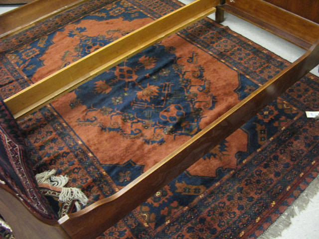 Appraisal: AFGHAN CARPET centering a dark blue diamond-shaped medallion on plain