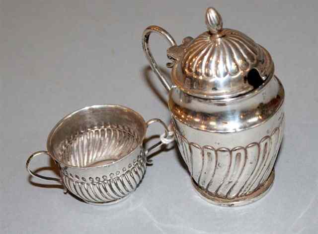 Appraisal: A BRITANNIA SILVER MINIATURE PORRINGER with wrythen sides and two