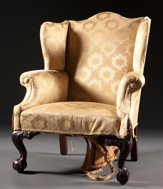 Appraisal: Centennial Chippendale style carved mahogany upholstered wing chair third quarter-