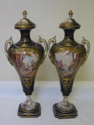 Appraisal: A PAIR OF CONTINENTAL POTTERY URNS of baluster form the