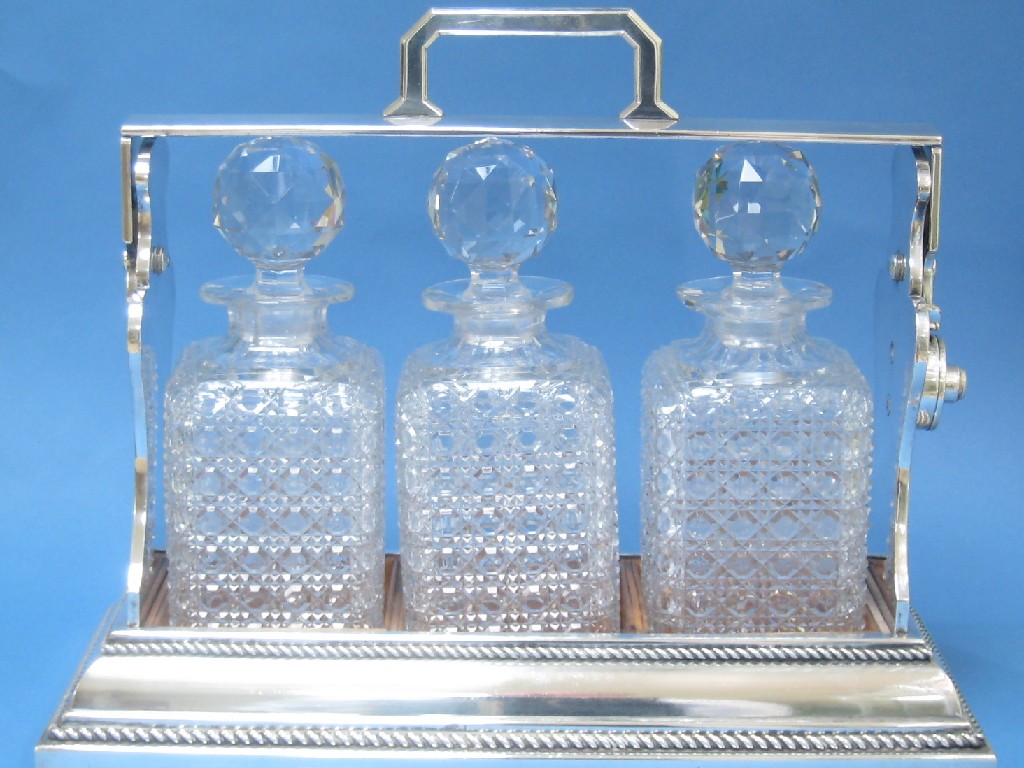 Appraisal: A plated cased three bottle Tantalus Betjemans patent with rope