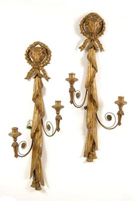 Appraisal: A pair of continental giltwood wall lights each with a