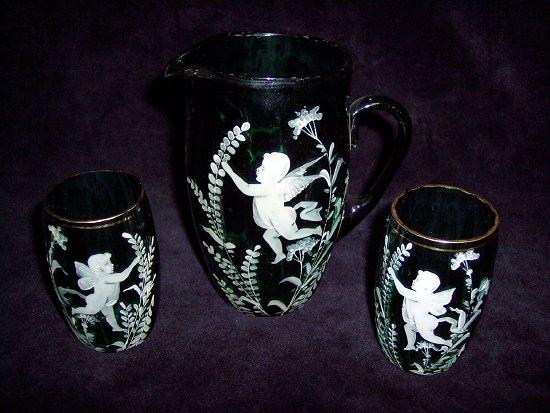 Appraisal: A Mary Gregory style green glass jug and two glasses