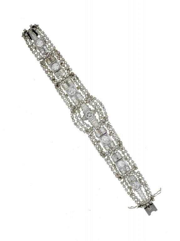 Appraisal: A DIAMOND BRACELET in seven hinged sections the centre with