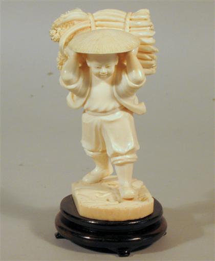 Appraisal: Chinese elephant ivory figure Single section boy farmer wood stand