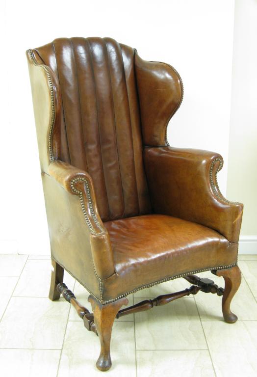 Appraisal: An early th Century Georgian style Winged Armchair with leather