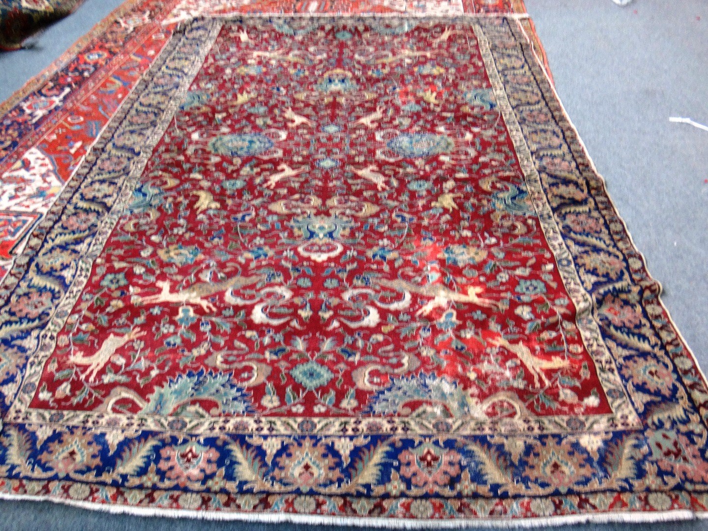 Appraisal: A Tabriz carpet Persian the burgundy field with palmettes cartouches