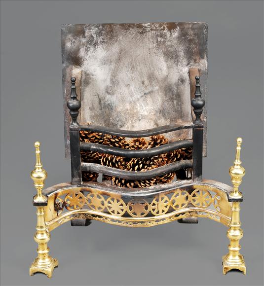 Appraisal: A George III cast iron and brass serpentine fire grate