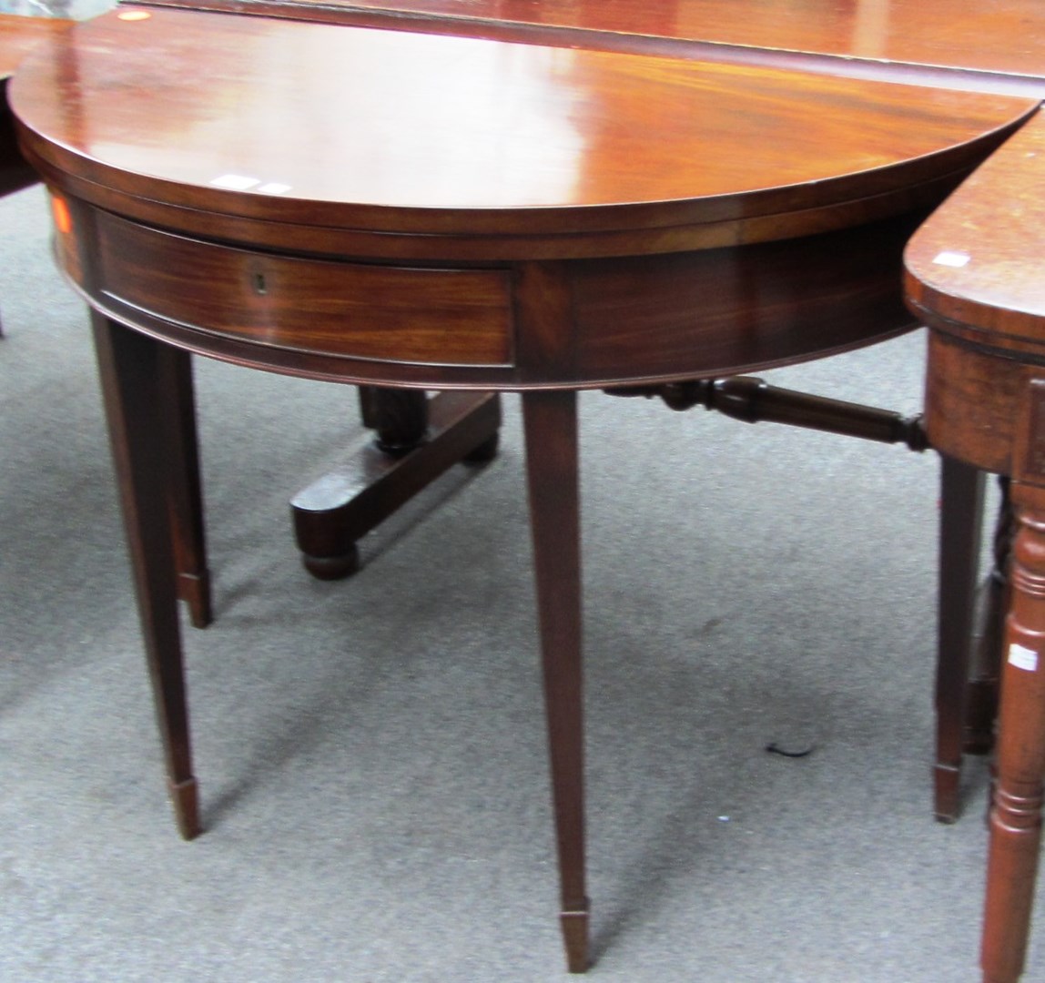 Appraisal: A George III mahogany semi elliptic tea table the frieze