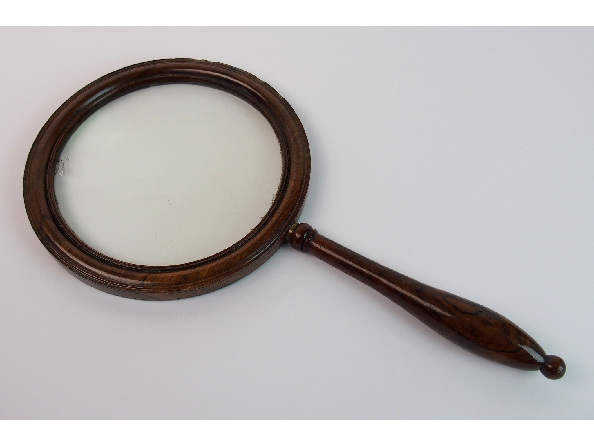 Appraisal: A th Century magnifying glassin rosewood frame with turned handle